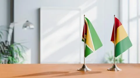 FLAGS OF GUINEA And GUYANA ON TABLE Stock Photos
