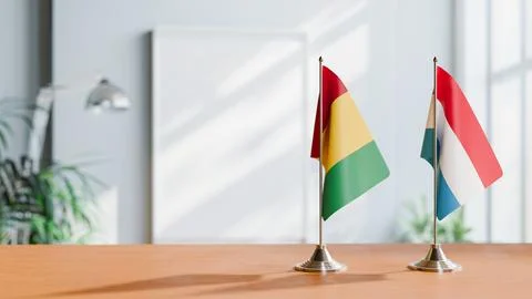 FLAGS OF GUINEA And LUXEMBOURG ON TABLE Stock Photos