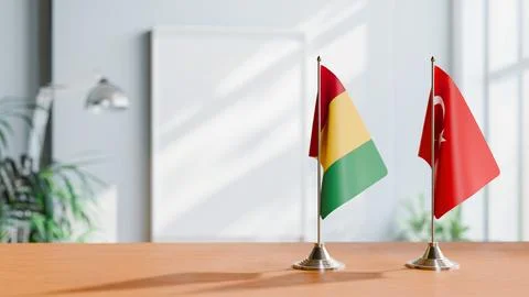 FLAGS OF GUINEA And TURKEY ON TABLE Stock Photos