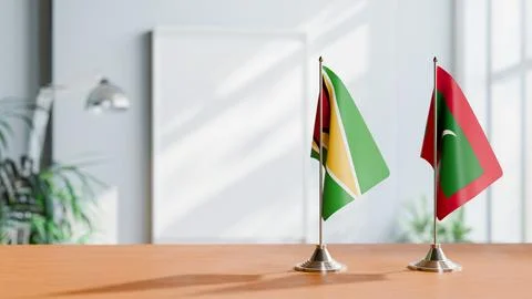 FLAGS OF GUYANA And MALDIVES ON TABLE Stock Photos