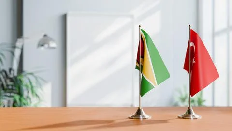 FLAGS OF GUYANA And TURKEY ON TABLE Stock Photos