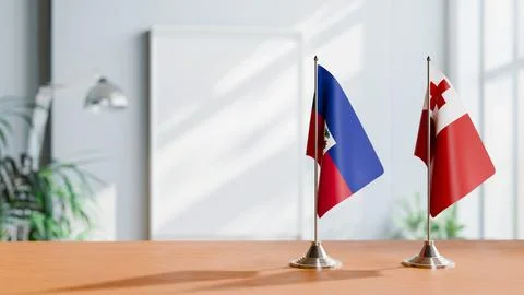 FLAGS OF HAITI And TONGA ON TABLE Stock Photos