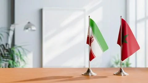 FLAGS OF IRAN AND MOROCCO ON TABLE Stock Photos