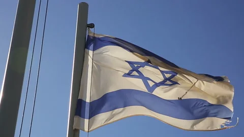 Flags of Israel flapping on mast in a wind Stock Footage 97498423