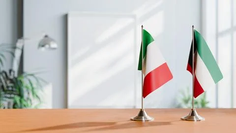 FLAGS OF ITALY AND KUWAIT ON TABLE Stock Photos