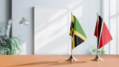 FLAGS OF JAMAICA AND TRINIDAD ON TABLE Stock Photos