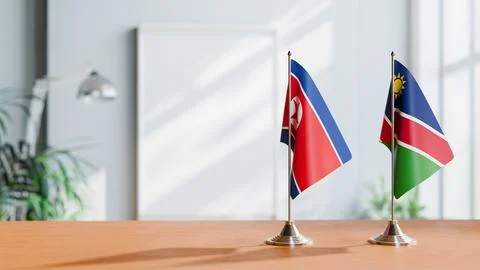 FLAGS OF KOREA NORTH AND NAMIBIA ON TABLE Stock Photos