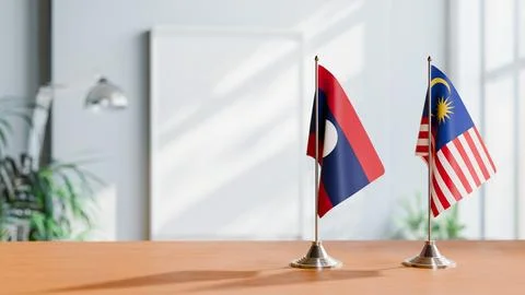 FLAGS OF LAOS AND MALAYSIA ON TABLE Stock Photos