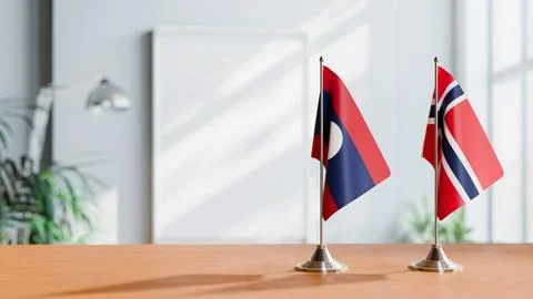 FLAGS OF LAOS AND NORWAY ON TABLE Stock Photos