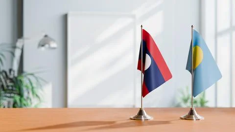 FLAGS OF LAOS AND PALAU ON TABLE Stock Photos