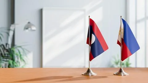 FLAGS OF LAOS AND PHILIPPINES ON TABLE Stock Photos