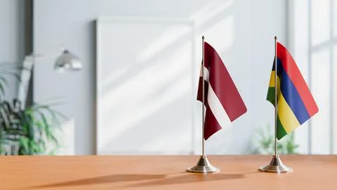 FLAGS OF LATVIA AND MAURITIUS ON TABLE Stock Photos