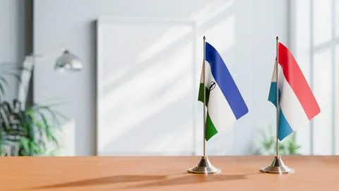 FLAGS OF LESOTHO AND LUXEMBOURG ON TABLE Stock Photos