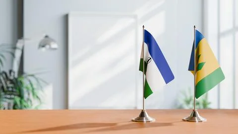 FLAGS OF LESOTHO AND SAINT VINCENT ON TABLE Stock Photos