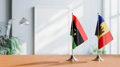FLAGS OF LIBYA AND MOLDOVA ON TABLE Stock Photos