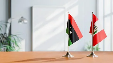 FLAGS OF LIBYA AND PERU ON TABLE Stock Photos