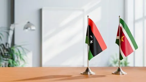 FLAGS OF LIBYA AND SURINAME ON TABLE Stock Photos