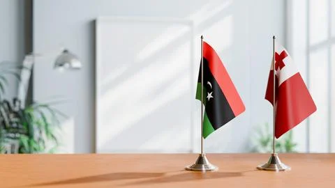 FLAGS OF LIBYA AND TONGA ON TABLE Stock Photos