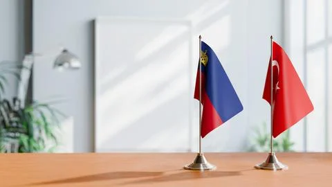 FLAGS OF LIECHTENSTEIN AND TURKEY ON TABLE Stock Photos