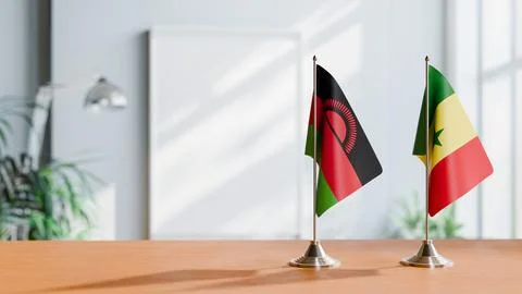 FLAGS OF MALAWI AND SENEGAL ON TABLE Stock Photos