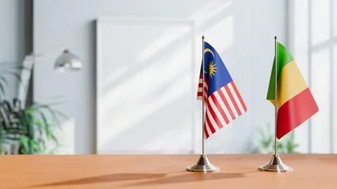 FLAGS OF MALAYSIA AND MALI ON TABLE Stock Photos