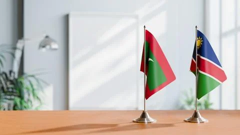 FLAGS OF MALDIVES AND NAMIBIA ON TABLE Stock Photos