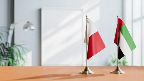 FLAGS OF MALTA AND UAE ON TABLE Stock Photos