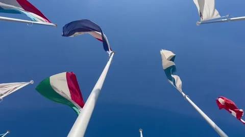 Flags of many countries waveing in the wind with blue sky from below Stock Footage 274935525