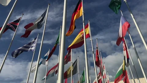 Flags of many countries waving in the wind on the blue sky and white clouds Stock Footage 98021274