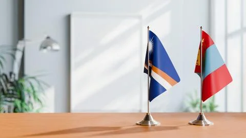 FLAGS OF MARSHALL ISLANDS AND MONGOLIA ON TABLE Stock Photos