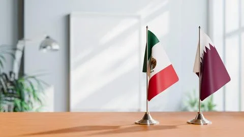 FLAGS OF MEXICO AND QATAR ON TABLE Stock Photos