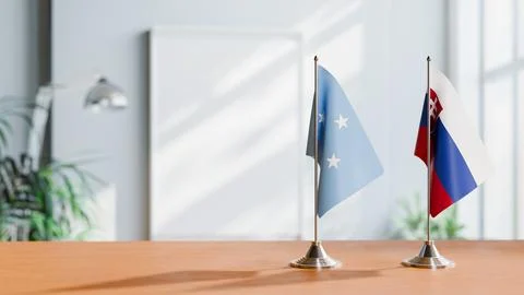 FLAGS OF MICRONESIA AND SLOVAKIA ON TABLE Stock Photos