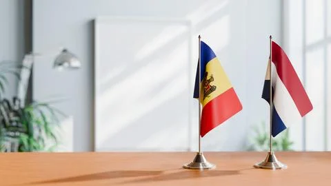FLAGS OF MOLDOVA AND NETHERLANDS ON TABLE Stock Photos