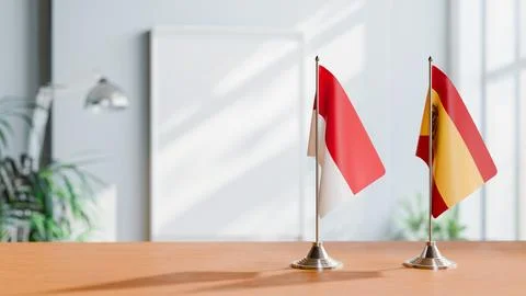 FLAGS OF MONACO AND SPAIN ON TABLE Stock Photos