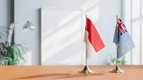 FLAGS OF MONACO AND TUVALU ON TABLE Stock Photos