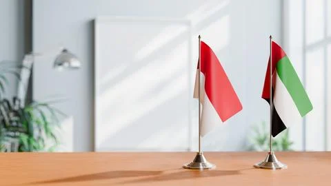FLAGS OF MONACO AND UAE ON TABLE Stock Photos