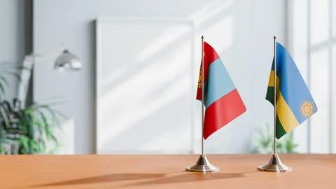 FLAGS OF MONGOLIA AND RWANDA ON TABLE Stock Photos