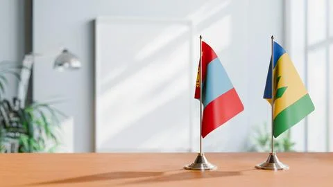 FLAGS OF MONGOLIA AND SAINT VINCENT ON TABLE Stock Photos