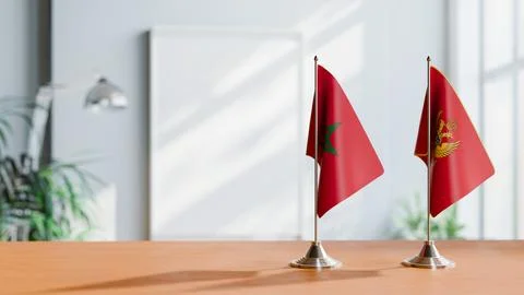 FLAGS OF MONTENEGRO AND MOROCCO ON TABLE Stock Photos