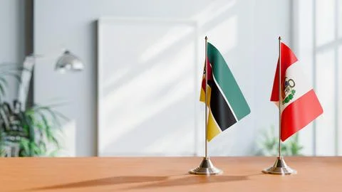 FLAGS OF MOZAMBIQUE AND PERU ON TABLE Stock Photos