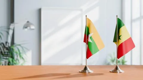 FLAGS OF MYANMAR AND SENEGAL ON TABLE Stock Photos