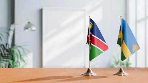 FLAGS OF NAMIBIA AND RWANDA ON TABLE Stock Photos