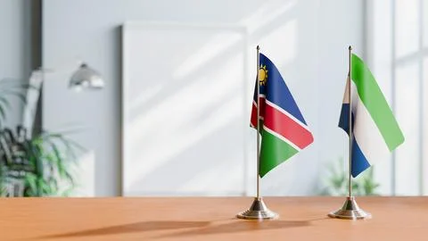 FLAGS OF NAMIBIA AND SIERRA LEONE ON TABLE Stock Photos