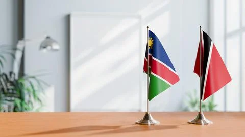 FLAGS OF NAMIBIA AND TRINIDAD ON TABLE Stock Photos