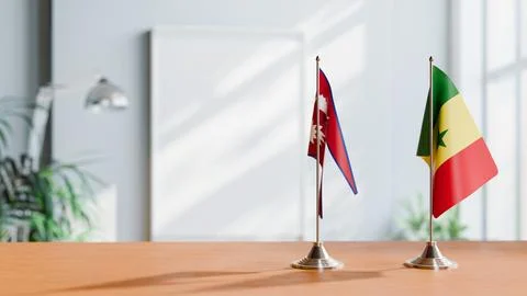 FLAGS OF NEPAL AND SENEGAL ON TABLE Stock Photos