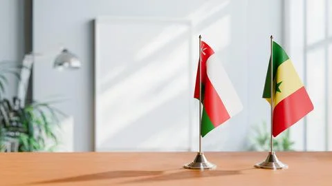 FLAGS OF OMAN AND SENEGAL ON TABLE Stock Photos