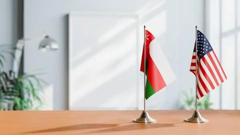 FLAGS OF OMAN AND USA ON TABLE Stock Photos