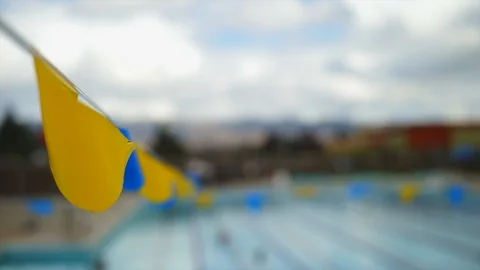 Flags over a swimming pool. 스톡 동영상 88405327