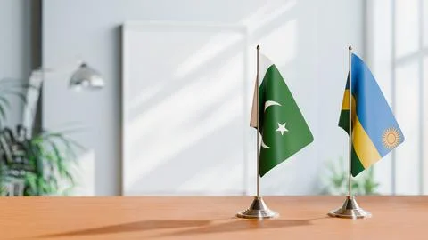 FLAGS OF PAKISTAN AND RWANDA ON TABLE Stock Photos