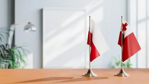 FLAGS OF POLAND AND TONGA ON TABLE Stock Photos
